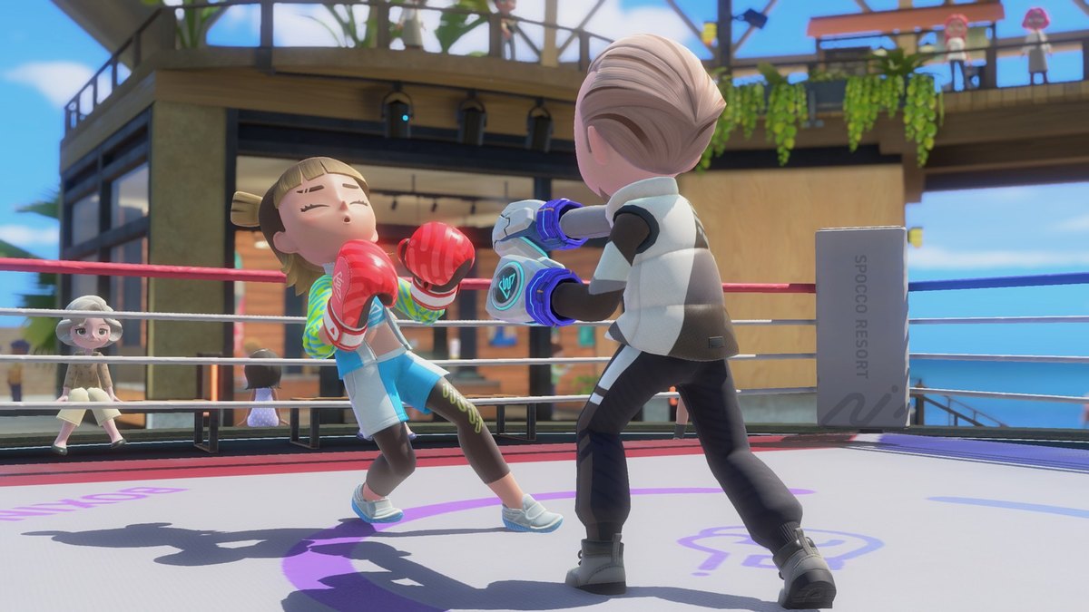 Two characters boxing in a ring overlooking the ocean in Nintendo Switch Sports Resort