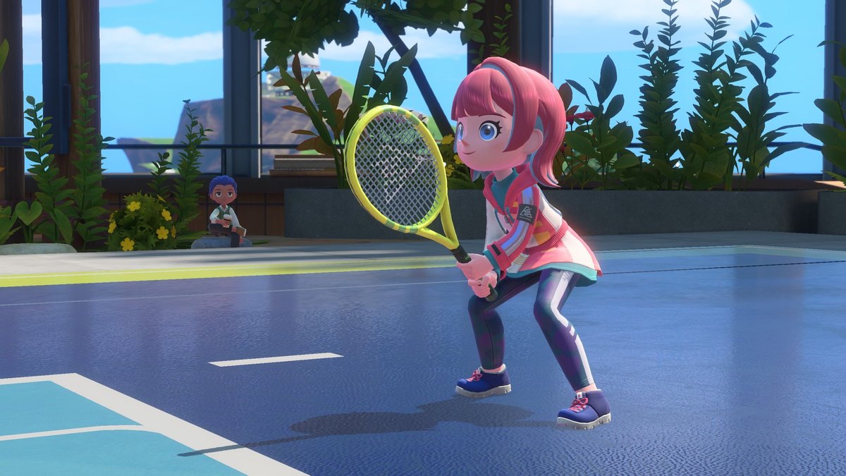 A pink-haired character with a yellow racket on a tennis court in Nintendo Switch Sports Resort