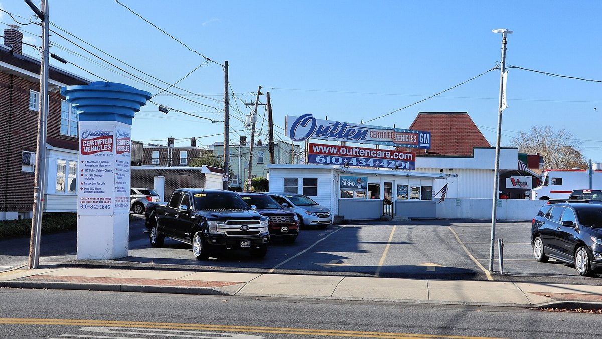 A franchised dealership lot with trucks and SUVs on display