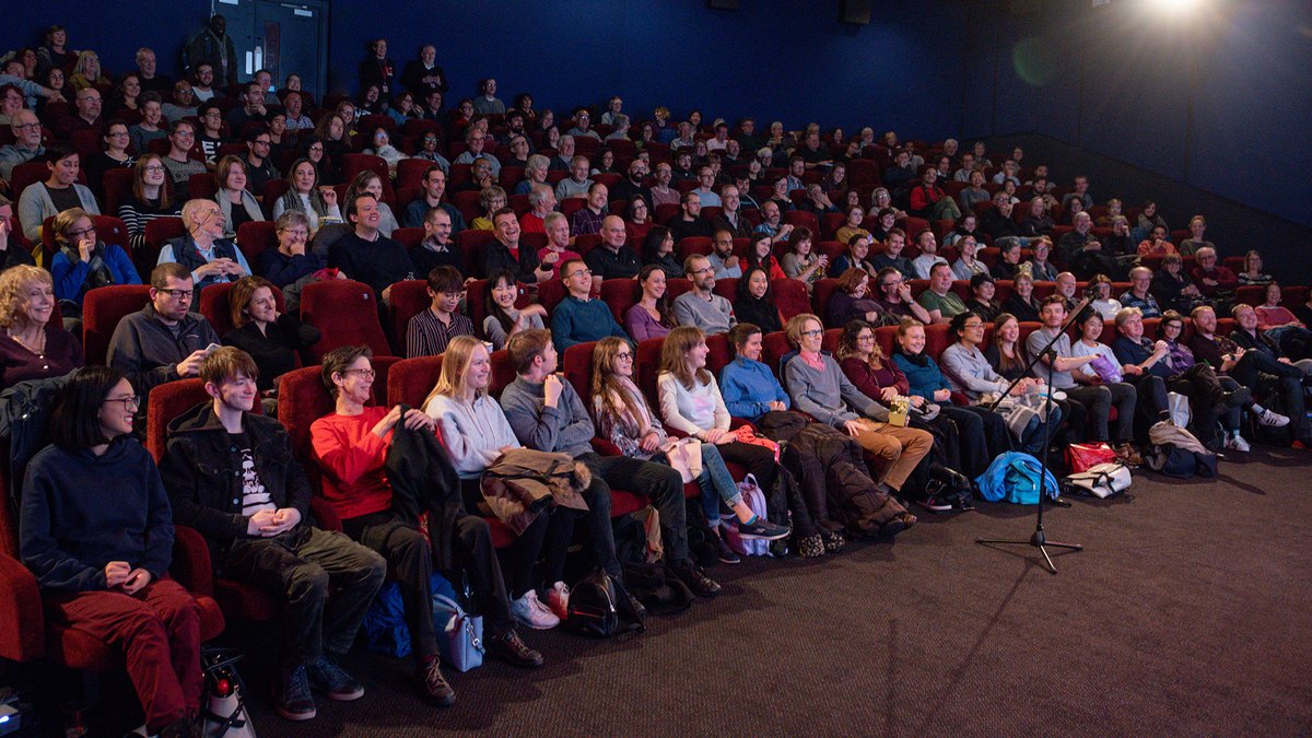 A full audience watching a screening in a cinema