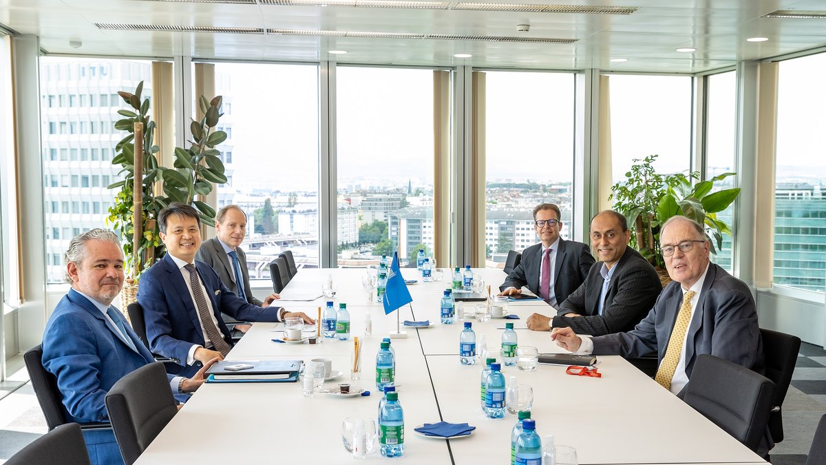 A boardroom meeting around a long table