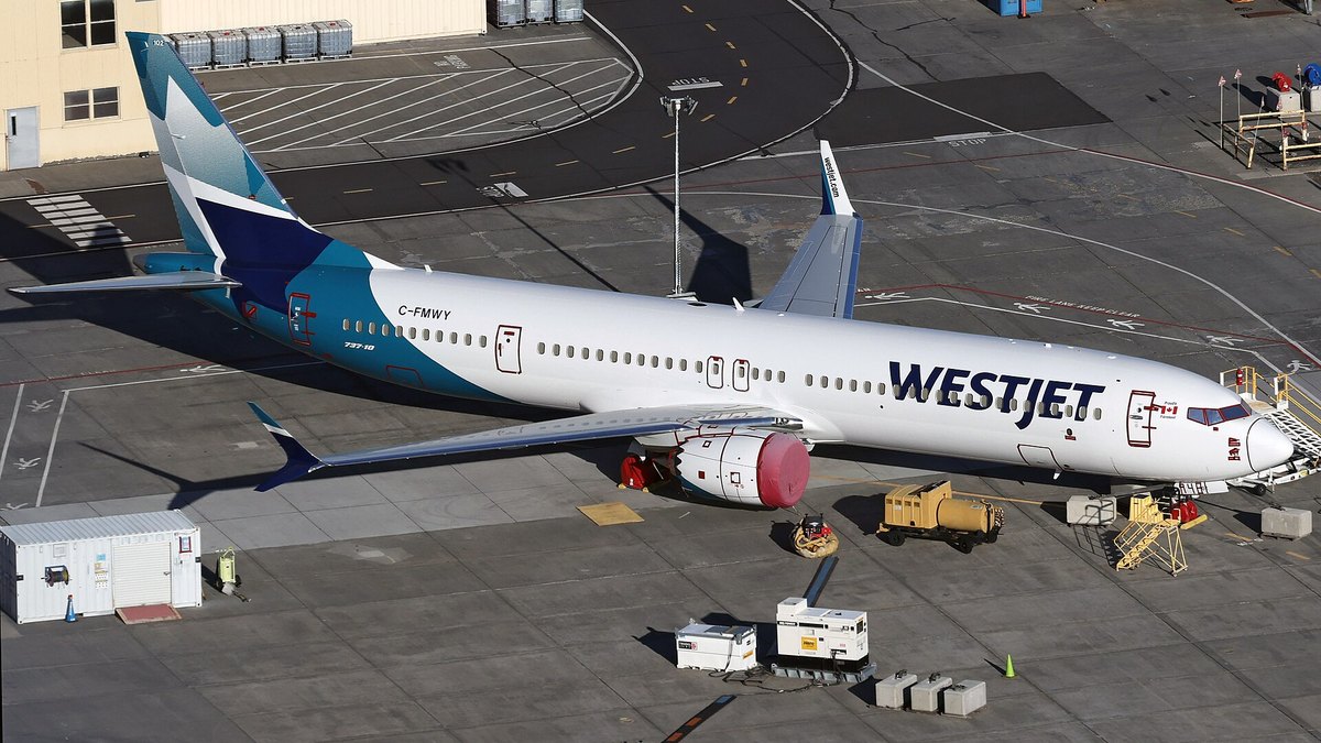 A WestJet Boeing 737 MAX 10 parked at an airfield