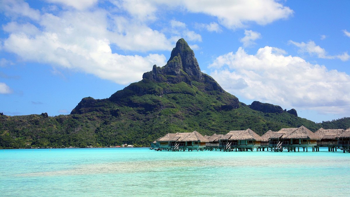 Mount Otemanu rising behind overwater bungalows in Bora Bora