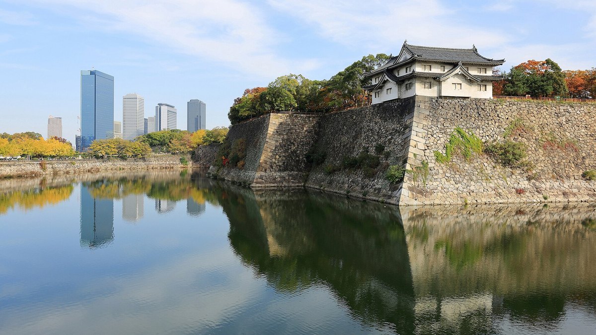 The outer moat of Osaka Castle with the Osaka Business Park skyline in the background
